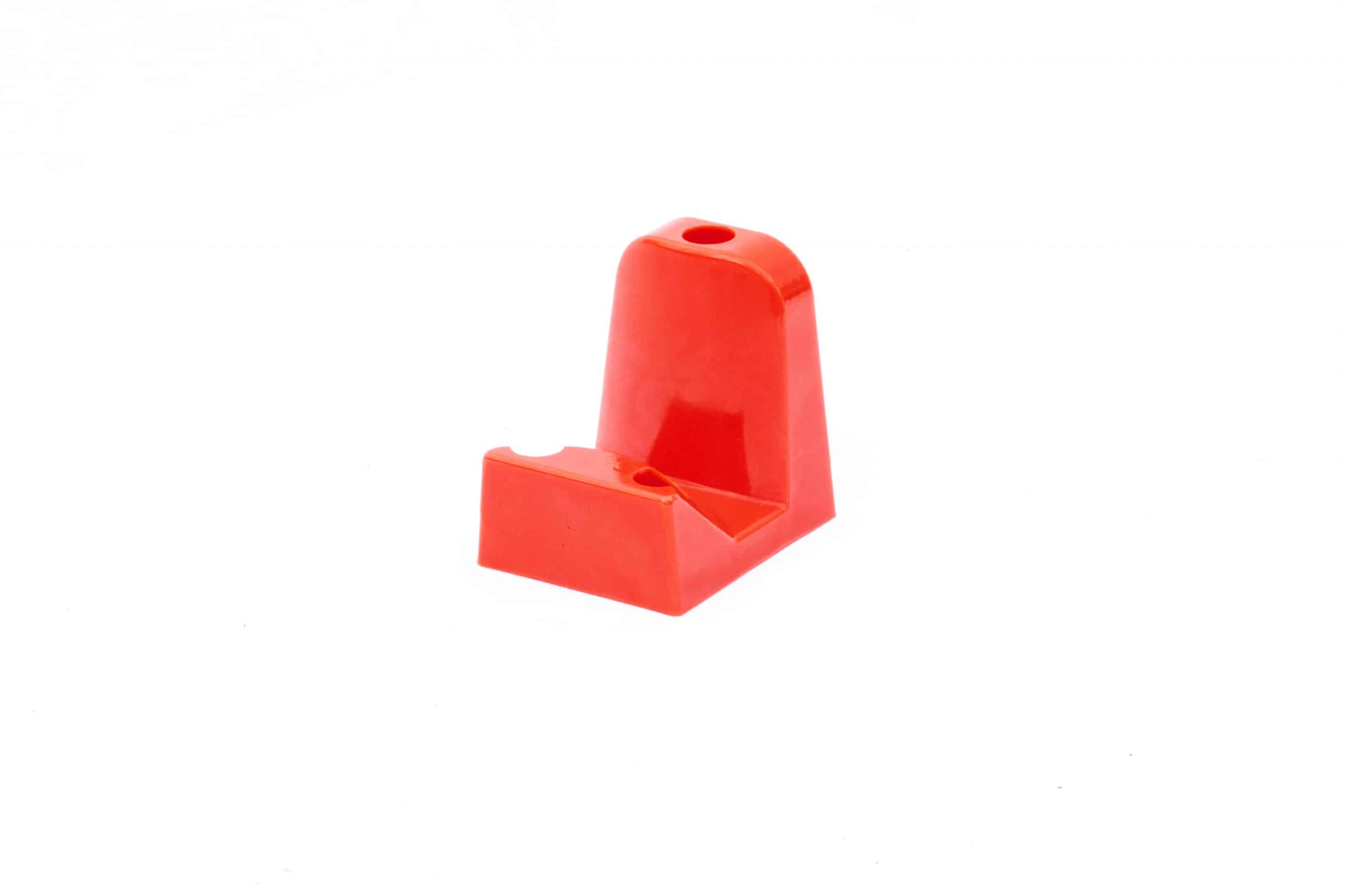 Orange polyurethane body block designed to hold a car door in assembly operations..