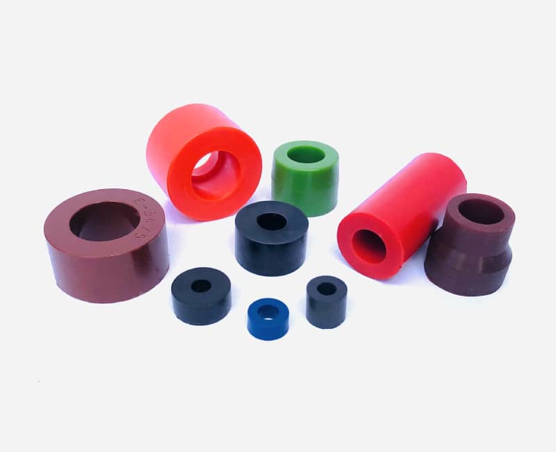 Array of different colored, custom polyurethane bushings.