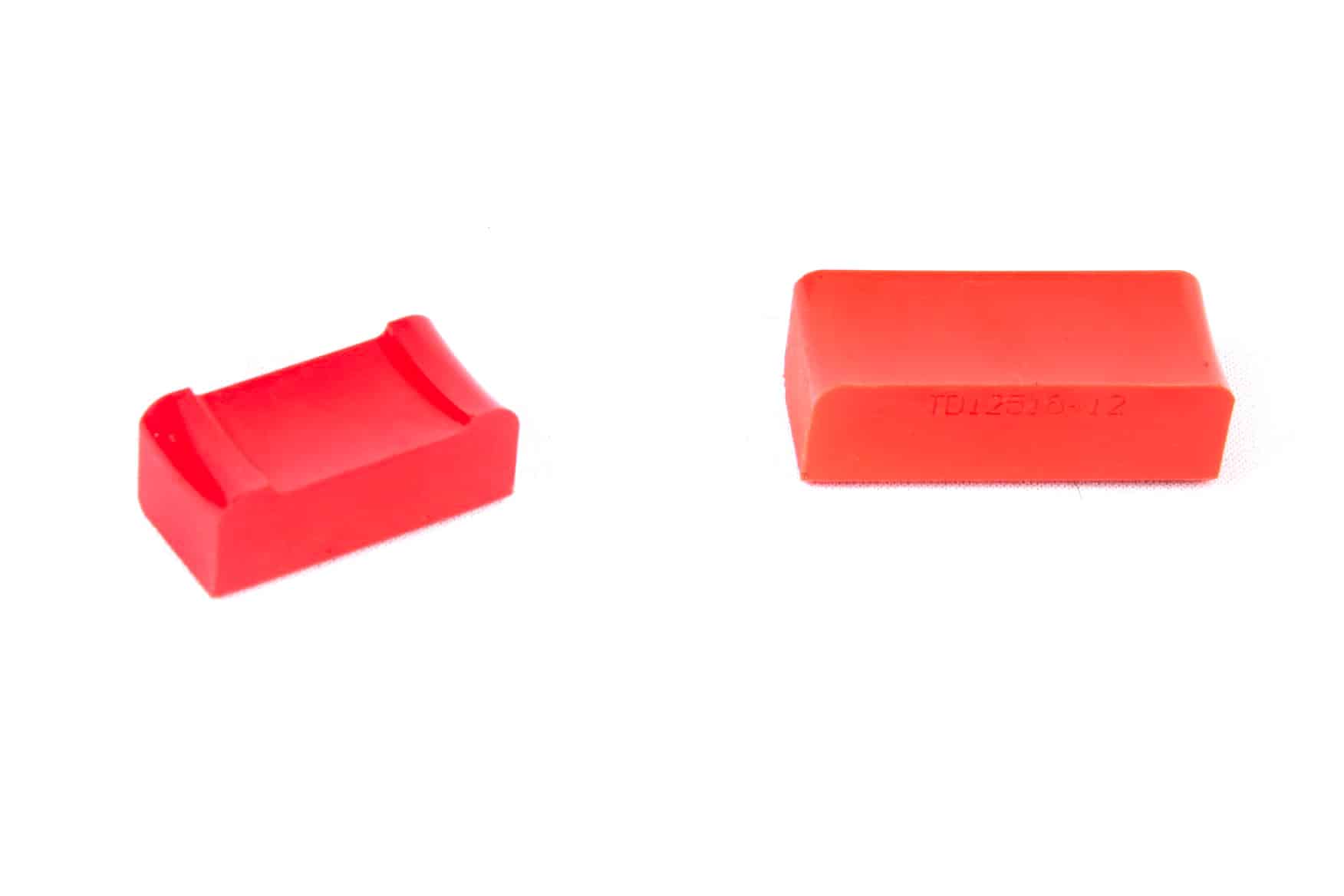 Small, red polyurethane pallets for carrying dunnage.
