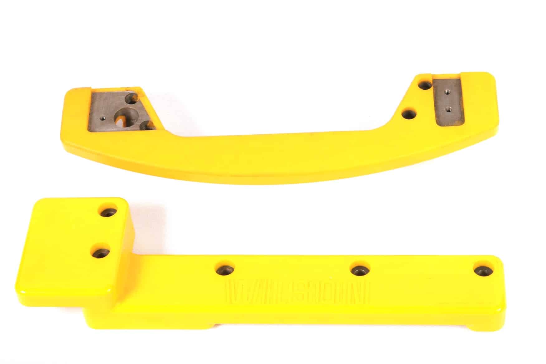 Large, yellow polyurethane bumpers with multiple metal inserts at connection points. 
